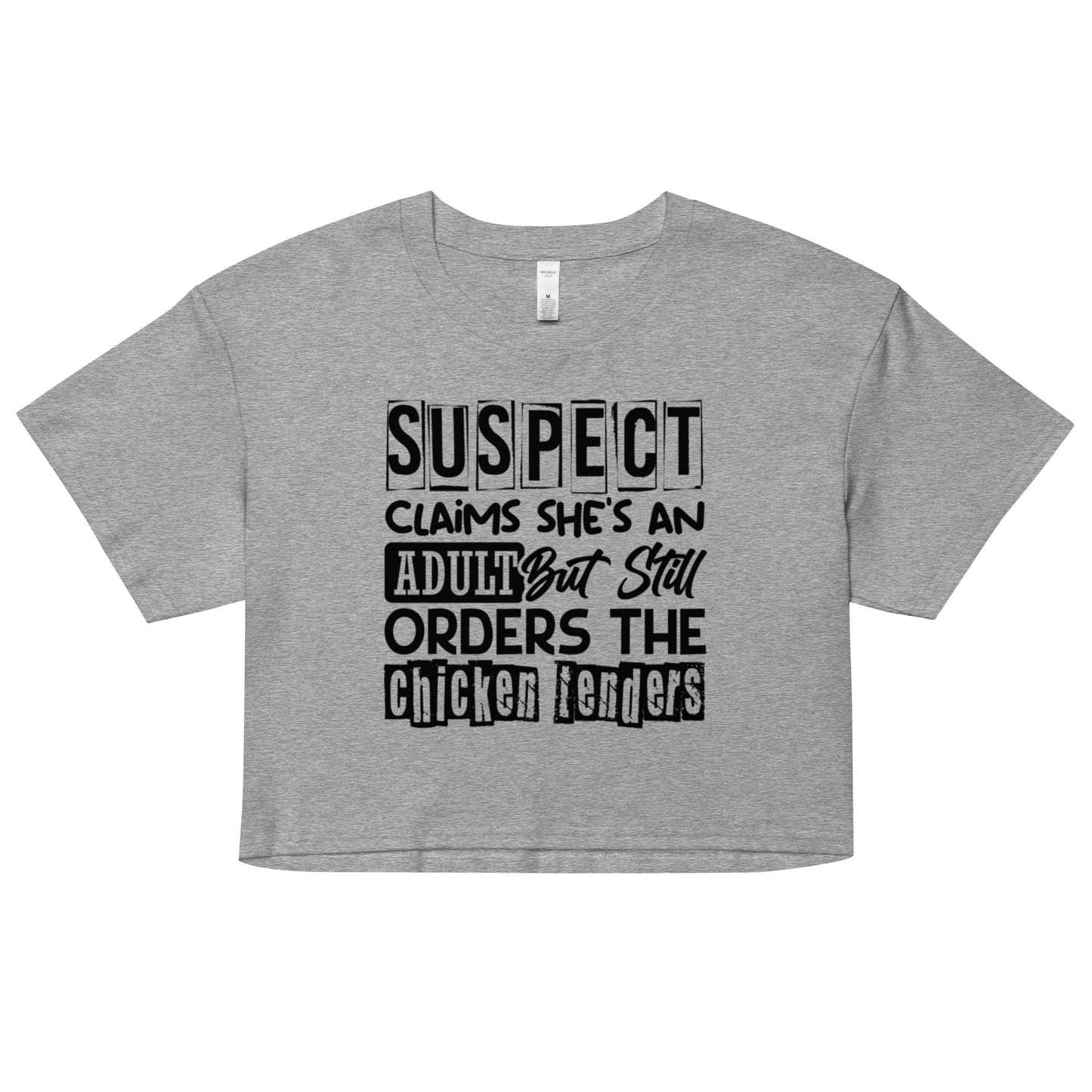 Gray crop top with black text “Suspect Claims She’s an Adult But Still Orders the Chicken Tenders”