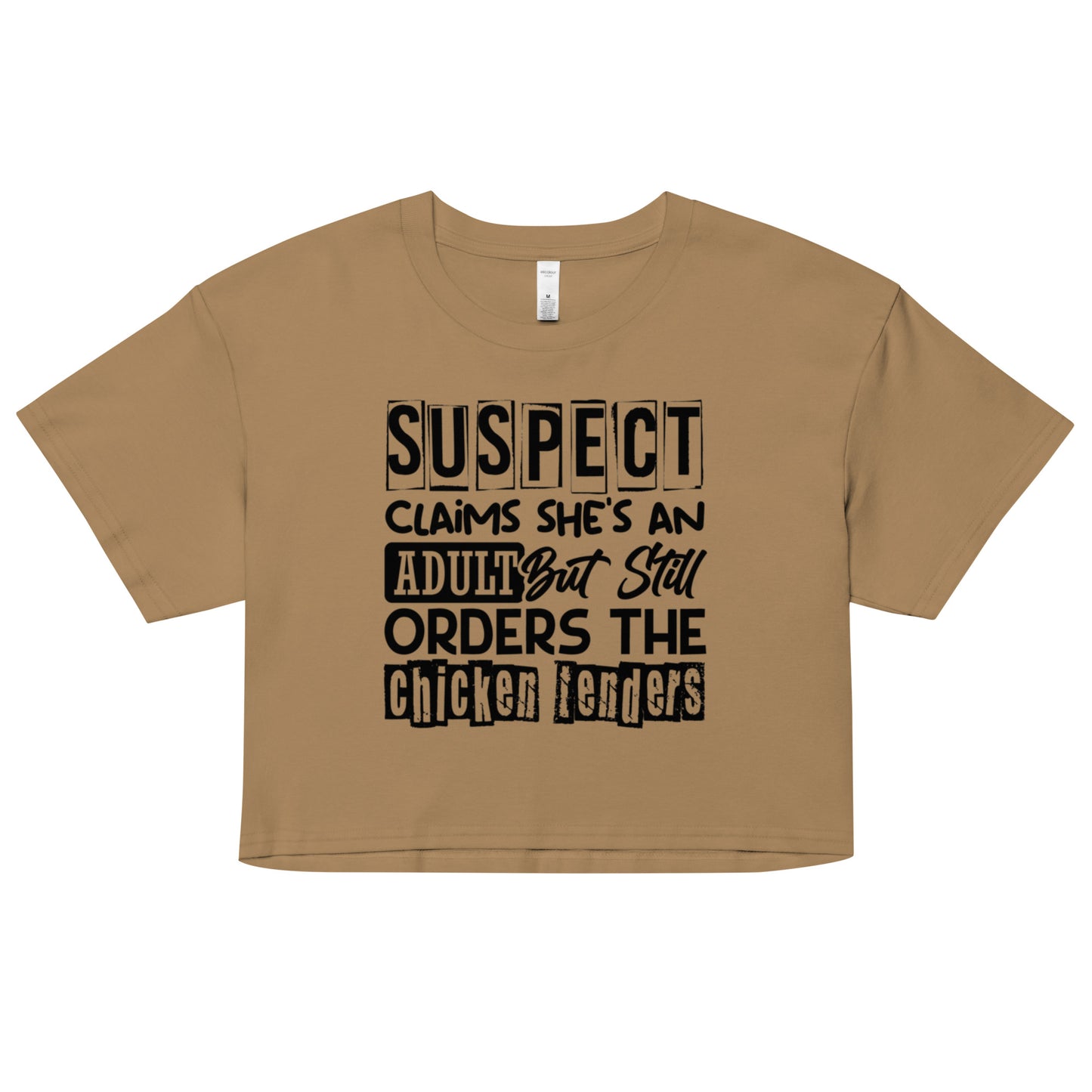 crop top with black text “Suspect Claims She’s an Adult But Still Orders the Chicken Tenders”