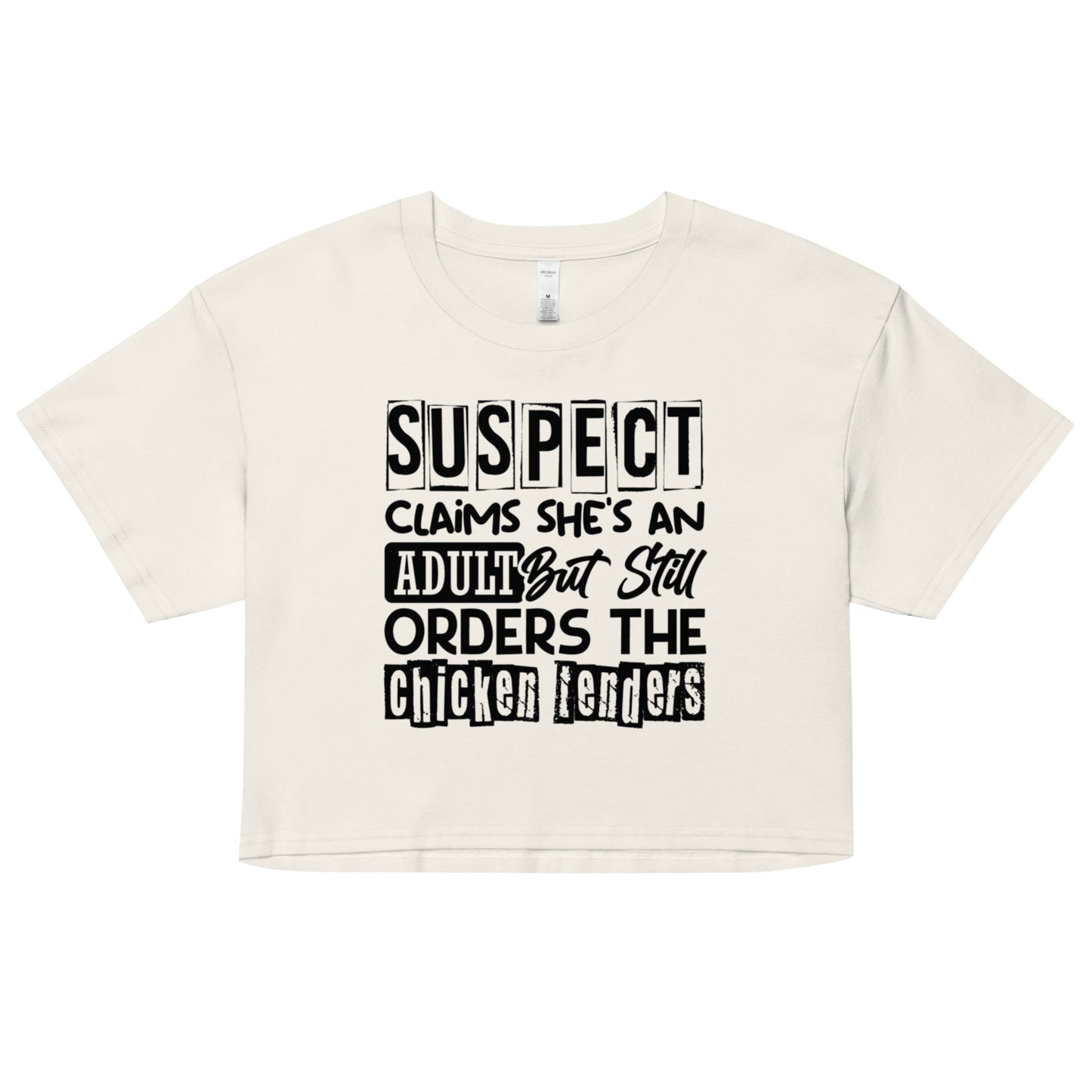 crop top with black text “Suspect Claims She’s an Adult But Still Orders the Chicken Tenders”