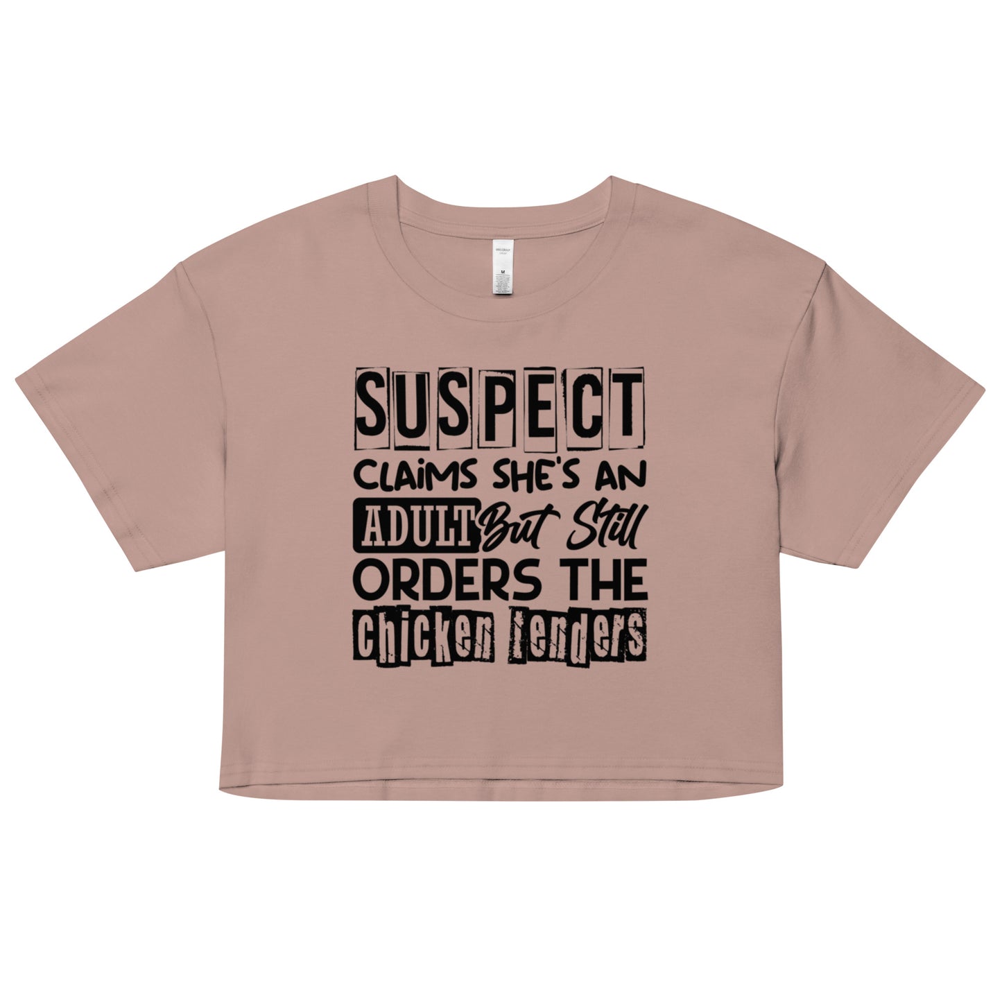 crop top with black text “Suspect Claims She’s an Adult But Still Orders the Chicken Tenders”